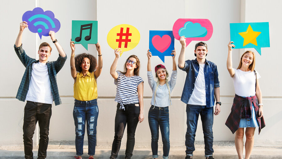 Young adult friends holding up copyspace placard thought bubbles